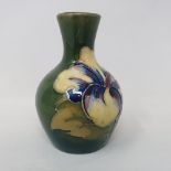A Moorcroft vase decorated with flowers, 9 cm high