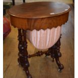 A Victorian mahogany oval work table, on turned end supports, joined by a pole stretcher, 65 cm wide