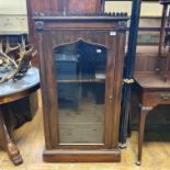 A Victorian rosewood pier style cabinet, the ogee shaped door with a glass panel, on a plinth