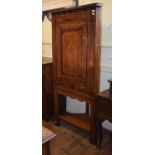 An oak corner cabinet, on a later base 172 cm high, and a 1920's walnut dressing table with three