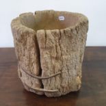 A 19th century treen mortar, made from the trunk of a tree, split and wormed, 38 cm high Report by