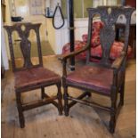 A set of eight 18th century style oak dining chairs, carved flowers and foliage, with leather