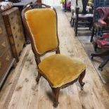 A 19th century mahogany nursing chair, on carved cabriole legs, and a harlequin set of eight oak