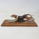 A painted bronze running dog paperclip, on an oak base, 28 cm wide Report by RB Modern