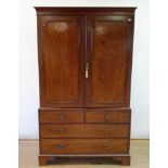 A 19th century mahogany linen press, with two doors above two short and two long drawers, on bracket