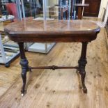 A 19th century walnut card table, on column supports, united by a stretcher, on carved splayed legs,