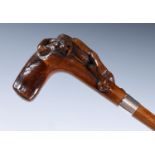 A 19th century fruitwood walking stick, with carved handle, in the form of a gorilla, with glass