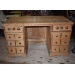 A late 19th century inlaid ash kneehole desk, in the manner of Bruce Talbot, 113 cm wide From a