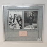 A Judy Garland autograph, framed alongside two black and white photographs and two posters promoting