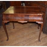 A mahogany silver table, the dished top with re-entrant corners, with two end frieze drawers, on