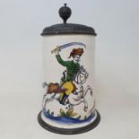 A Continental faience tankard, decorated with a soldier on horseback, with pewter mounts, 26 cm