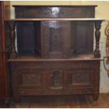 An 18th century style oak cabinet, the back, above central cupboard flanked by open sections above