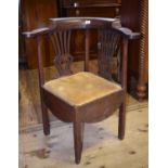 A George III oak corner chair, with a pierced splat, drop in seat, on square legs, and five