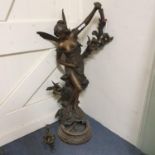 A large Art Nouveau spelter figural lamp, of a scantily clad fairy holding flowers, on round base,