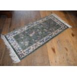 A Chinese part silk green ground rug, 127 x 152 cm