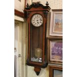 A Vienna regulator style clock, the 16 cm diameter enamel dial with Roman numerals, in a walnut