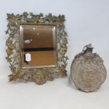 A 19th century Continental gilt metal flask, 17 cm high and a table mirror in a metal frame, 24 x 28