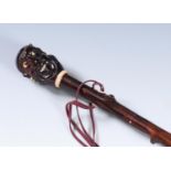 A 19th century walking stick, with carved handle, in the form of a head of a sailor with glass eyes,