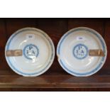 A pair of George I Delft plates, initialled JPA (Joseph & Ann Player) and dated 1725 within a circle