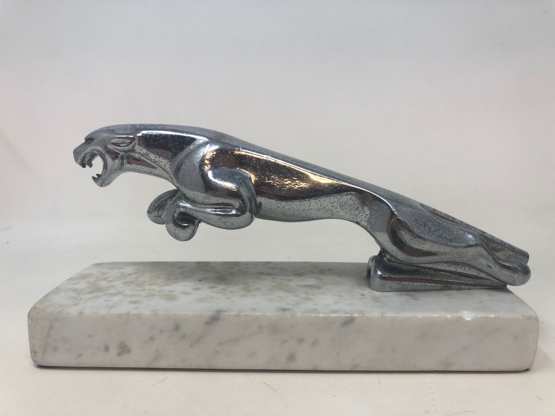 A chrome leaping Jaguar bonnet mascot, lacks tail, on a marble base, and two other hood ornaments - Image 4 of 6