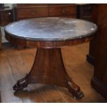 A French Guerridon, the dished marble top on a mahogany base, of tapering triangular form, with leaf