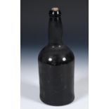 A 19th century glass wine bottle, 24 cm high