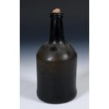 A 19th century glass wine bottle, 24 cm high