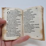 An Italian 18th century prayer book, incomplete, wormed, pages torn, velum, sold with all faults not