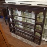 An 18th century style oak wall hanging plate rack, 130 cm wide