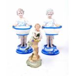 A pair of early 20th century Dresden figures, of a young boy and girl holding baskets, 22 cm high, a