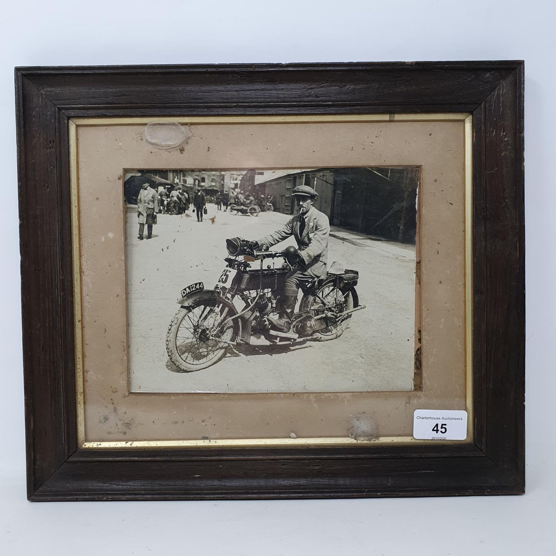 A monochrome photograph, Eric Williams on an AJS (DA 1244), 16 x 20.5 cm Provenance: Being sold