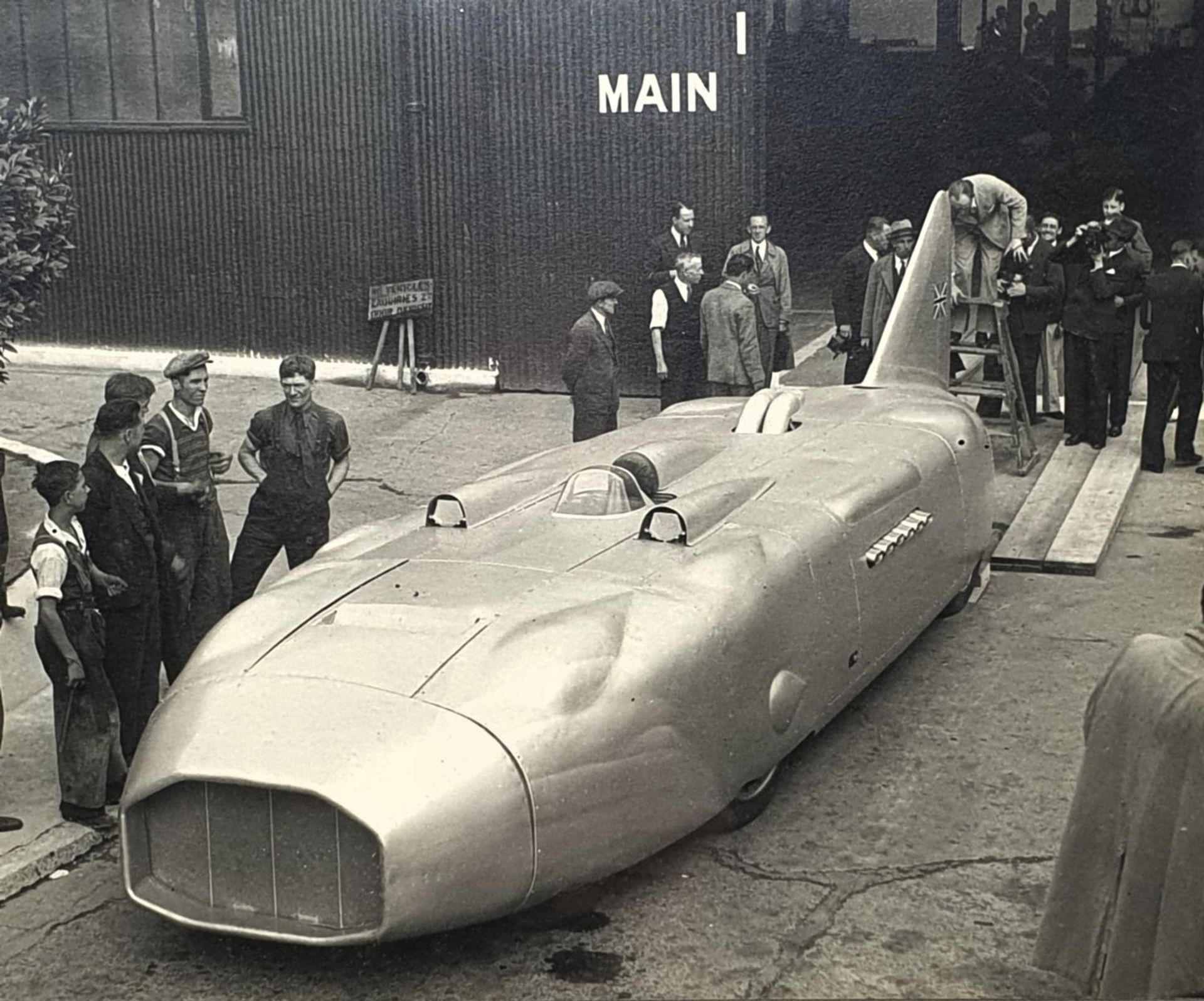 An Autocar monochrome photograph, Thunderbolt land speed record car driven by George Eyston, 24 x 29 - Image 2 of 2