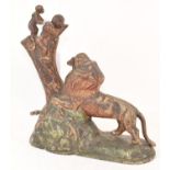 A painted cast metal novelty money box, in the form of a monkey and infant feeding a lion, 24 cm