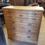 An early 20th century ash chest, having a bonnet drawer, flanked by four short drawers above three