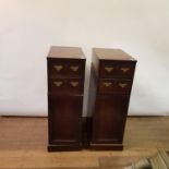 A pair of mahogany pedestals, having two drawers, above cupboard doors, 109 cm high x 36 cm wide (2)