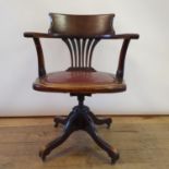 An early 20th century walnut desk chair, with a red leather seat JS- tilt, fall and drop mechanism