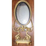 An ormolu dressing table mirror, with scrolled mount, decorated with flowers and festoons, on shaped