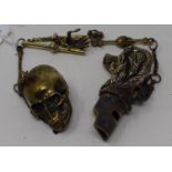 A modern brass fob chain, with pendants to include a whistle, a skull, a hand Report by JS Note: