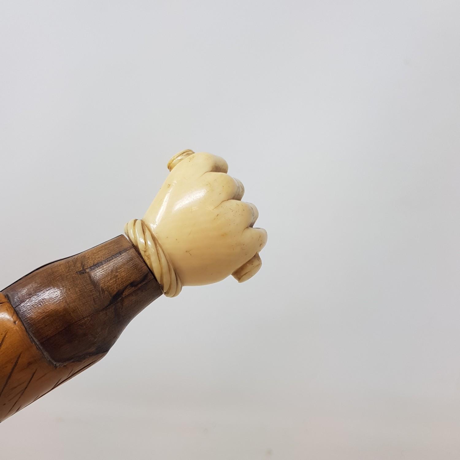 An Early 20th century walking stick, with carved ivory handle in the from of a hand, on a foliate - Image 3 of 6