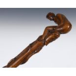 A 19th century folk art walking stick, the handle carved in the form of a naked woman crouched