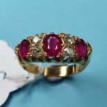 A yellow coloured metal, diamond and ruby ring, having three rubies interspersed by four diamonds,
