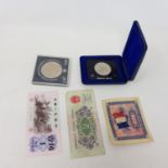 A Bahamas $10 Independence 1973 coin, other assorted coins and a small group of banknotes