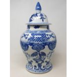 A Chinese blue and white vase and cover, decorated with birds and dragons, 49 cm high