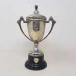 A silver trophy cup and cover, inscribed, Birmingham 1935, 22 cm high, on a socle base, 27.5 cm high