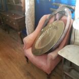 A pink armchair, a Benares type brass tray on a carved wood stand, and a modern carpet (3)