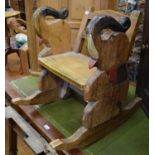 A child's rocking chair with elephant handles, a rocking horse, a pine corner cupboard, a pine