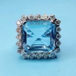 An 18ct white gold ring, with a large aquamarine within a surround of 20 diamonds, ring size M by RB