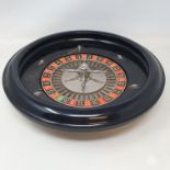 A roulette wheel and gaming counters, a brass trivet, a 19th century mahogany and brass bound