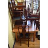 An oak kitchen table, with a formica top, 152 cm wide, and a set of six Queen Anne style mahogany