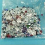Various loose mixed stones, including cubic zirconia, amethyst, ruby, emerald, sapphire and blue